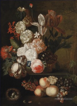 Roses tulipes violettes et autres fleurs dans un panier en osier sur un rebord de pierre avec des pêches de raisins et un nid avec des oeufs Jan van Huysum Peinture à l'huile